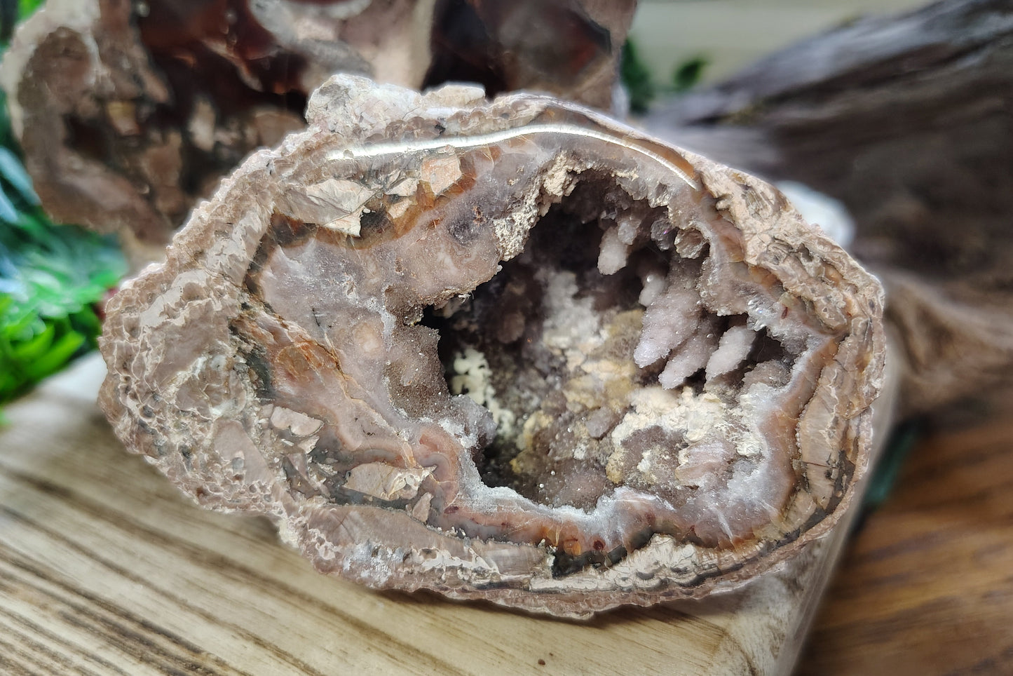 Geode with crystal formation on a wooden surface