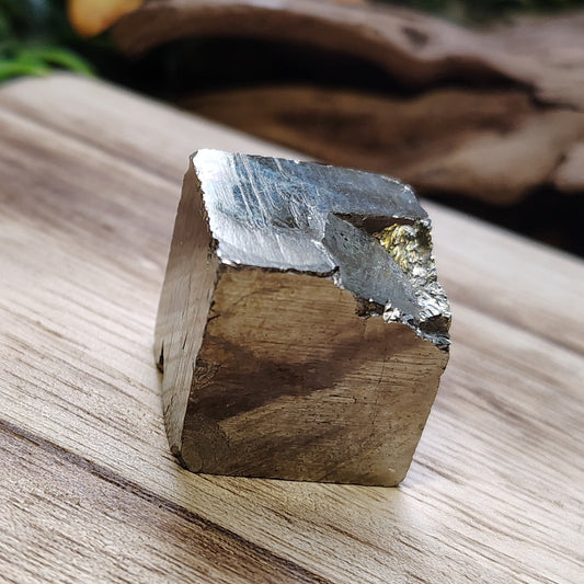 Crystal on a wooden surface with natural elements in the background
