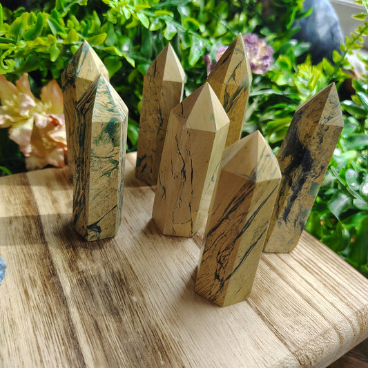 jasper towers on a wooden platform surrounded in greenery
